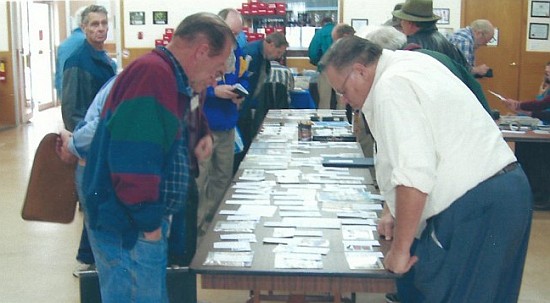 Members inspecting a table auction